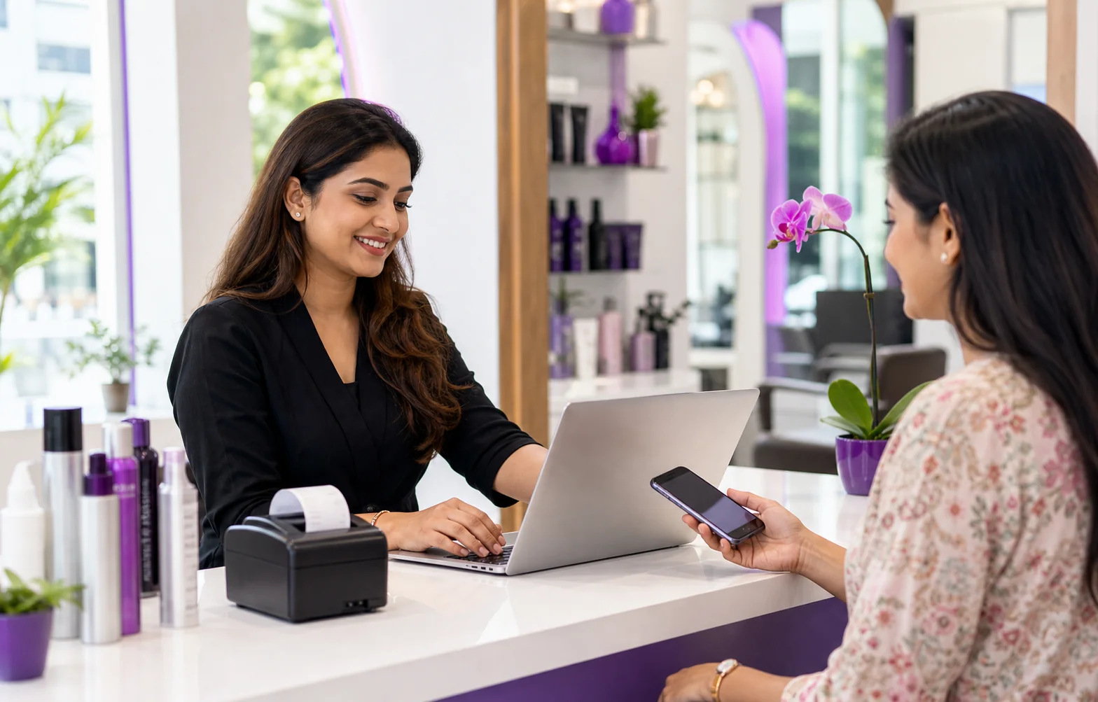 Indian salon owner creating a GST bill while a customer pays by phone